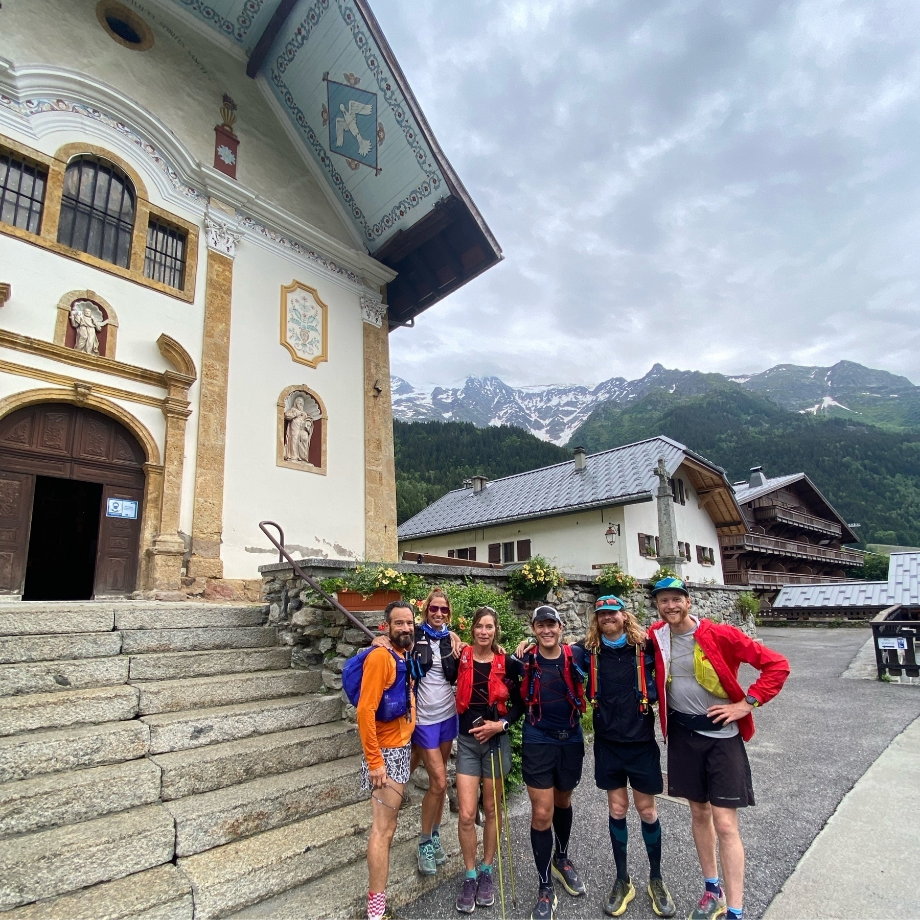 runners in front of the 18th cent church in Les Contamines, France. 
